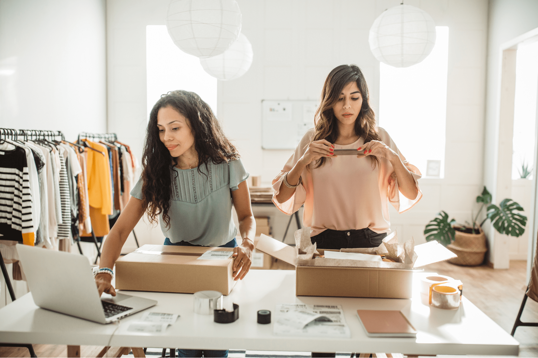 two female entrepreneurs working in their clothing business