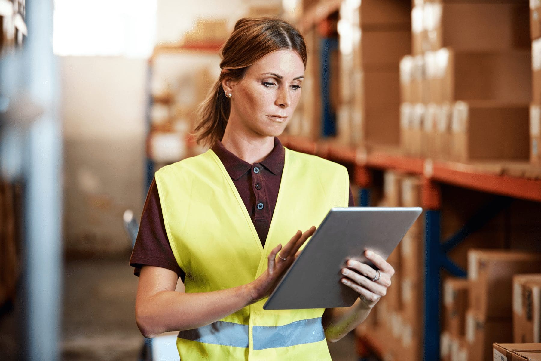 distribution center worker on her tablet managing her cyber supply chain risk