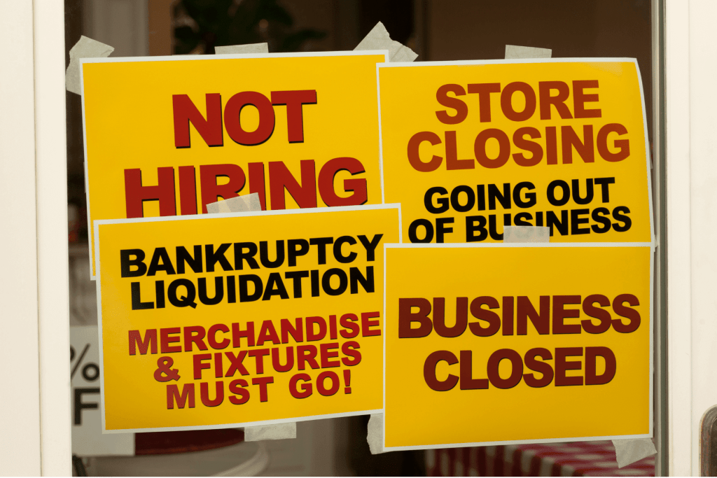small business with store closing signs on door illustrating the recession impact